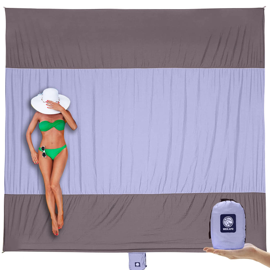 WEKAPO Beach Blanket Sandproof, Extra Large Beach Mat, Big & Compact Sand Free Mat Quick Drying, Lightweight & Durable with 6 Stakes & 4 Corner Pockets (Purple, 7x7 FT (1~3 person))